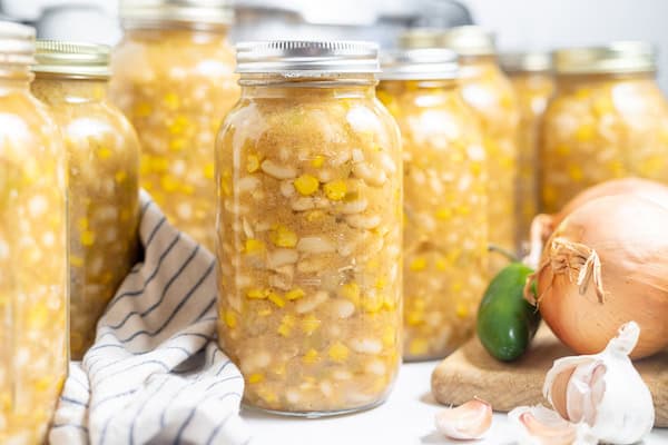 jars of canned chicken chili on a table