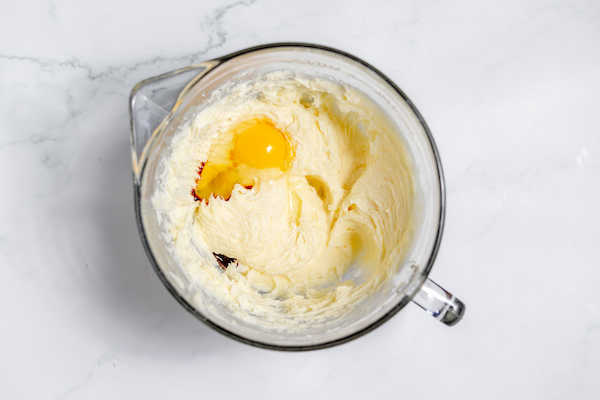 eggs and vanilla in butter and sugar mix
