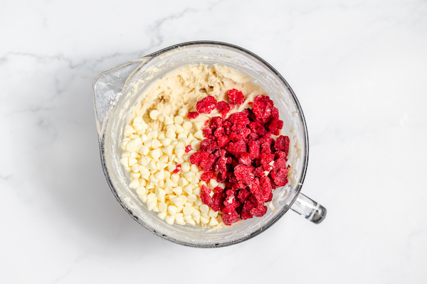 raspberries and white chocolate chips added to mixing bowl