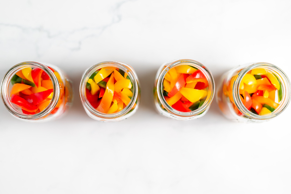 jars of bell peppers on a table