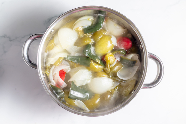 tomatillos, peppers, and onions in a pot